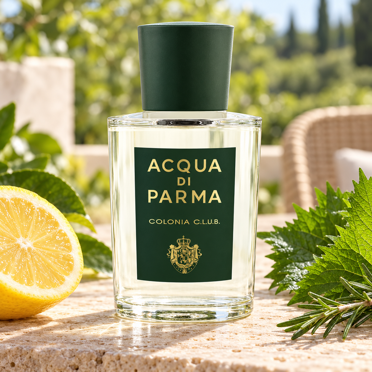 Acqua di Parma Colonia C.L.U.B. bottle on a sunlit stone terrace beside a lemon half, shiso leaves, and rosemary.