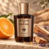 Acqua di Parma Colonia Sandalo bottle on warm stone beside an orange half, sandalwood pieces, and lavender in golden sunlight.