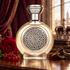 Boadicea the Victorious Monarch with a red rose, red currants, and oud wood against burgundy drapery and a softly blurred royal crown.