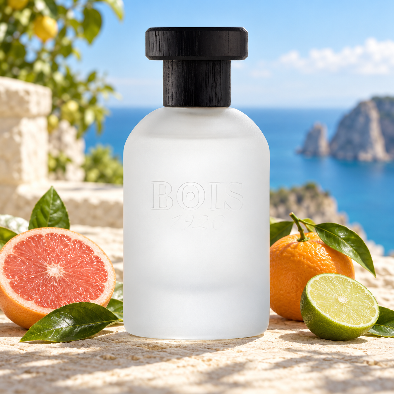 Bois 1920 Agrumi Amari di Sicilia’s frosted bottle beside grapefruit, orange, and lime on sunlit limestone overlooking a blue Mediterranean coast.