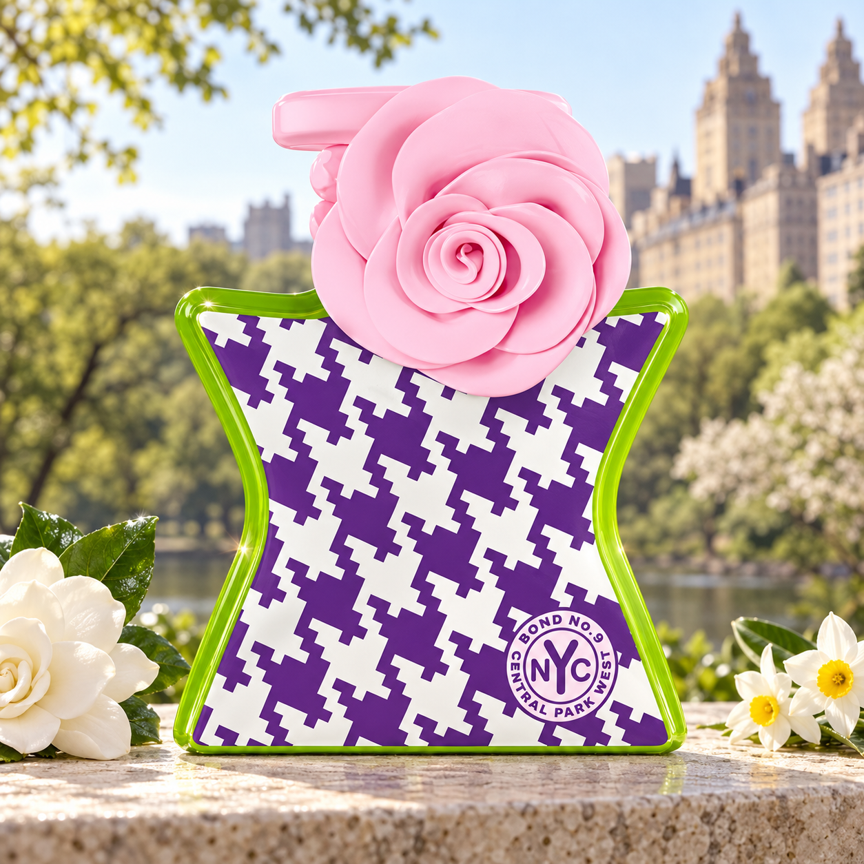 Bond No. 9 Central Park West on a sunlit stone ledge with gardenia and narcissus flowers, overlooking greenery and softly blurred Manhattan buildings.