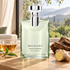 Bvlgari Pour Homme Eau de Parfum with tea, ginger, and guaiac wood beside an open doorway overlooking green woodland.