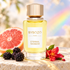 ByBozo Eternal Rainbow bottle with grapefruit, blackberries and a red flower against a softly lit rainbow background.
