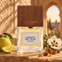 Carner Barcelona Ambar del Sur stands beside bergamot, cistus flowers, and myrrh resin in warm light beneath a Moorish arch.