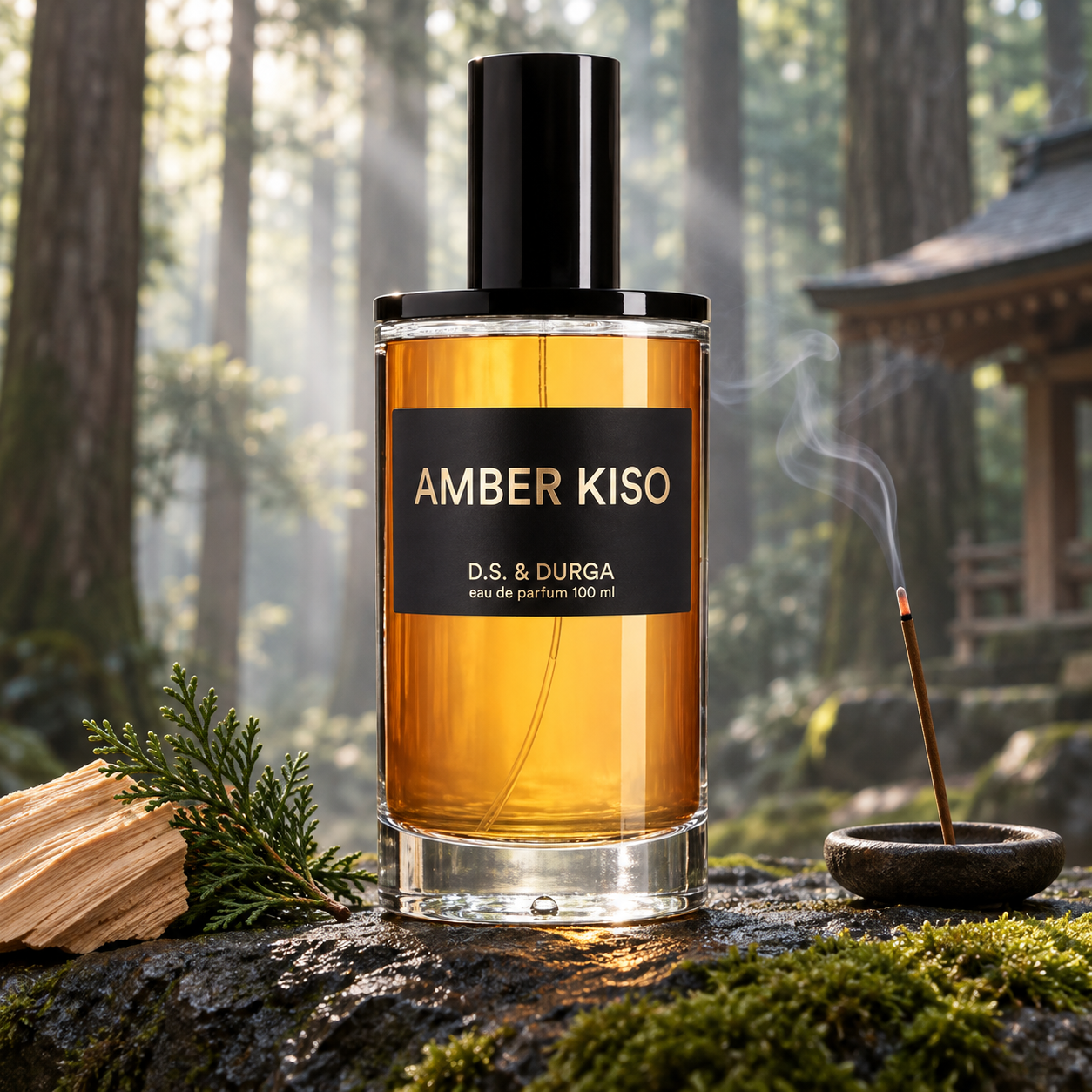 D.S. & DURGA Amber Kiso bottle on mossy stone beside hinoki wood, a cypress sprig, and smoking incense, with forest trees and a wooden shrine softly blurred behind it.