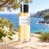 Dior Eden-Roc bottle with jasmine and pine on sunlit limestone overlooking a blue Mediterranean cove.