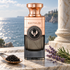 Electimuss Black Caviar beside a spoon of caviar, lavender, and rosemary on pale marble overlooking the sea, with a classical column behind it.