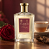 Floris A Rose For… beside a crimson rose, a cup of tea, and oud wood in warm window light.
