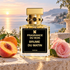 Fragrance Du Bois Brume du Matin beside mandarin, a peach half, and a pink rose on a stone terrace overlooking a misty Mediterranean sunrise.
