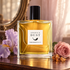 Francesca Bianchi Angel’s Dust on a walnut dressing table beside lilac iris, a dusty-pink rose, and amber resin, with an antique mirror in soft warm light.