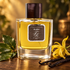 Franck Boclet Amber stands beside bay leaves, a yellow ylang-ylang flower, and vanilla pods on dark wood in golden light.