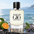 Giorgio Armani Acqua di Giò Eau de Parfum on wet coastal stone beside green mandarin, sage, and lavender, with a softly blurred blue sea.