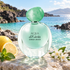 Giorgio Armani Acqua di Gioia on sunlit pale stone beside lemon, mint, and white jasmine, overlooking a turquoise island cove.