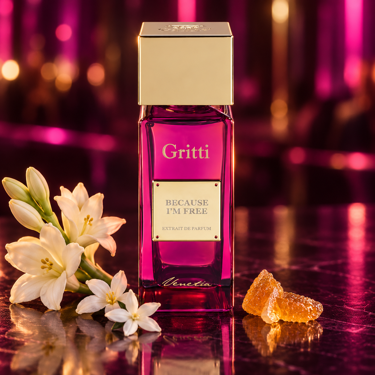 Gritti Because I’m Free beside white flowers and candied citrus on a reflective surface, with magenta and amber nightlife lighting.