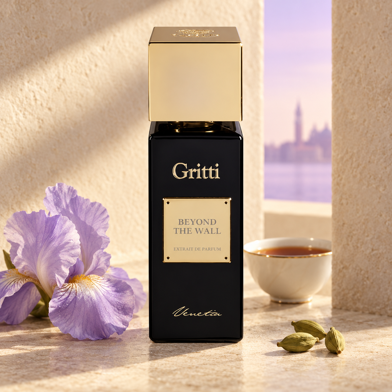 Gritti Beyond the Wall beside pale purple iris, black tea, and cardamom on cream stone, with soft light through a narrow architectural opening.