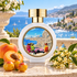HFC Dazzling Girls perfume bottle with apricots, golden Mirabelle plums, and creamy blossoms on a sunlit terrace overlooking the blue Côte d’Azur.