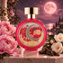 HFC Pink Moon perfume bottle framed by pink peonies, pale camellias, and oud wood on a stone terrace beneath a glowing pink moon.
