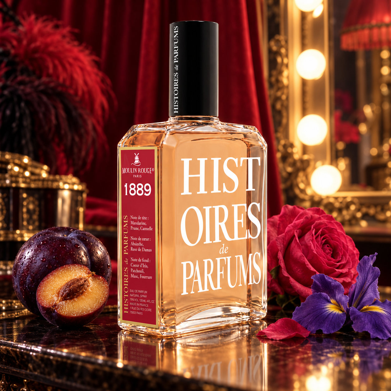 Histoires de Parfums 1889 Moulin Rouge bottle with plum, rose, and iris against red velvet curtains and a glowing dressing-room mirror.