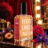 Histoires de Parfums 1889 Moulin Rouge bottle with plum, rose, and iris against red velvet curtains and a glowing dressing-room mirror.