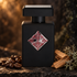 Initio Mystic Experience bottle with coffee beans, sandalwood, and oakmoss on dark stone in warm amber lighting.