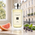 Jo Malone London 154 Cologne with grapefruit, lavender, and basil on a pale stone windowsill overlooking London-style townhouses.