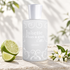 Juliette Has A Gun Anyway beside fresh lime and white blossoms on pale stone, illuminated by soft sunlight and leafy shadows.