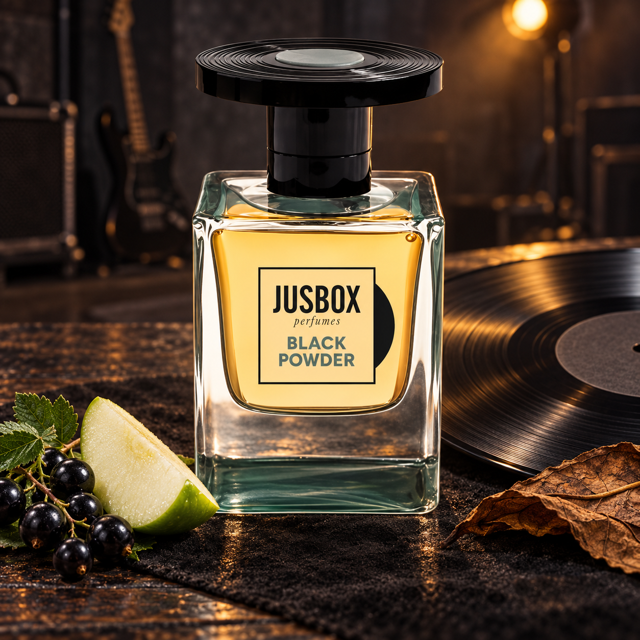 usbox Black Powder beside a vinyl record, blackcurrants, an apple wedge, and a tobacco leaf, with a guitar softly blurred under warm backstage lighting.