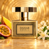 Kajal Dahab Absolu perfume with passion fruit, mango, and white blossoms on golden stone.