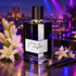 L’Orchestre Parfum Bouquet Encore with white flowers and vanilla pods under violet club lighting, overlooking Barcelona beside a turntable.