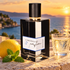 L’Orchestre Parfum Electro Limonade bottle with a whole lemon, mint and sparkling drink on a Mediterranean terrace at sunset.