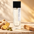 Laurent Mazzone Acqua Zenzero on pale limestone beside fresh ginger, green cardamom pods, and sandalwood in warm golden light.