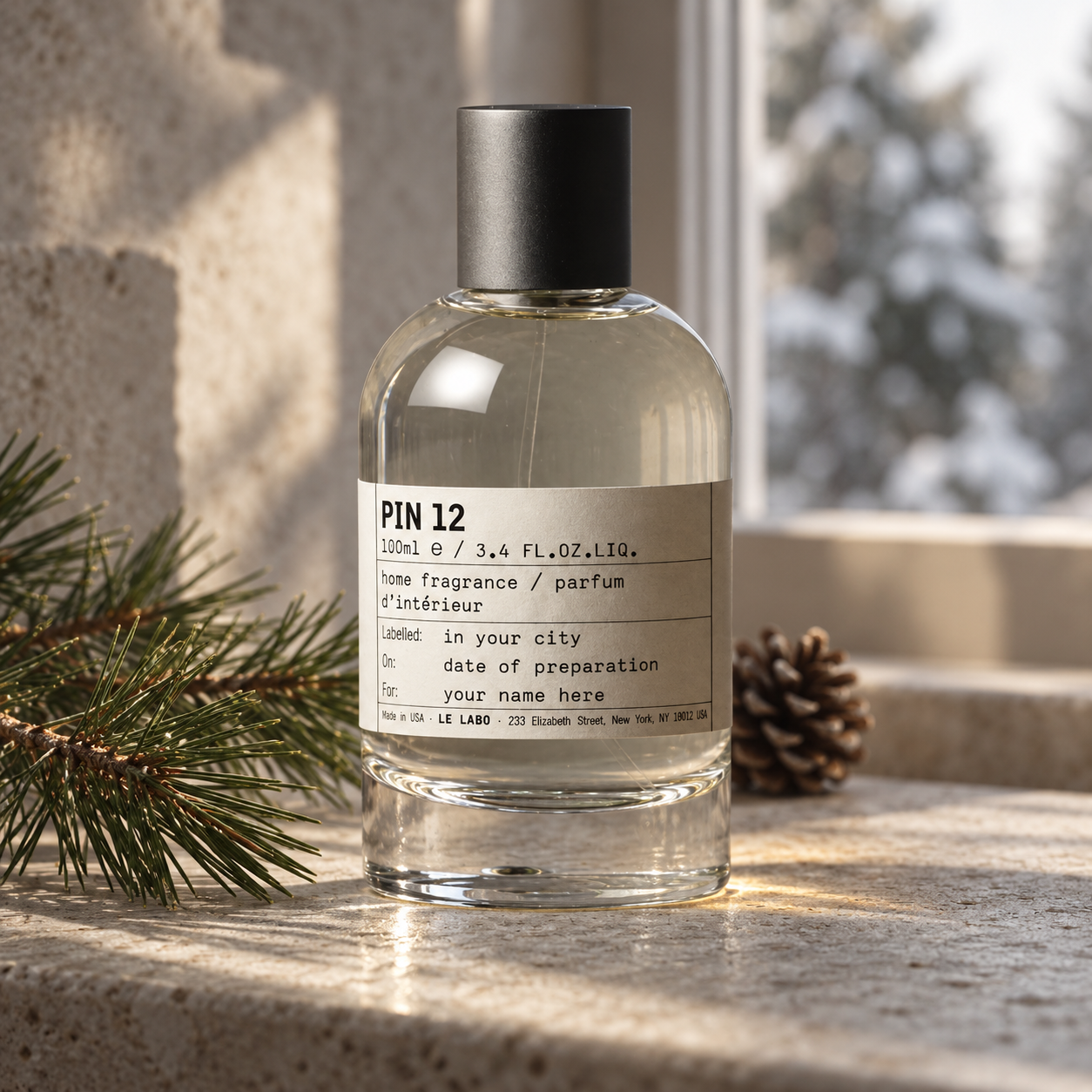 Le Labo PIN 12 home fragrance bottle beside pine branches and a pinecone on pale stone, illuminated by soft winter window light.