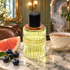 Les Bains Guerbois 1900 L’Heure de Proust perfume bottle with blueberries, pink pomelo, and steaming tea on marble in a Belle Époque-inspired Paris salon.