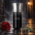 Les Liquides Imaginaires Beauté du Diable on wet cobblestones beside a red carnation and wormwood, with drifting mist and warm streetlamp light.