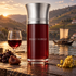 es Liquides Imaginaires Bello Rabelo beside port wine, dried fruit, and immortelle, overlooking a Rabelo boat and terraced vineyards at sunset.