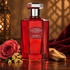 Lorenzo Villoresi Alamut’s ruby-red bottle beside a dusky rose, golden osmanthus blossoms, and sandalwood, with burgundy velvet and warm lattice shadows behind it.