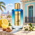 Mancera Aoud Lemon Mint beside lemon, almonds, and white jasmine on sunlit stone, with pastel Havana-style architecture behind it.