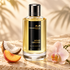 Mancera Aoud Orchid beside coconut, peach, and a pale pink orchid on cream travertine in soft golden light.