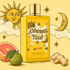 Illustrated yellow Mes Bisous bottle surrounded by a smiling sun, crescent moon, clouds, citrus, and ginger.
