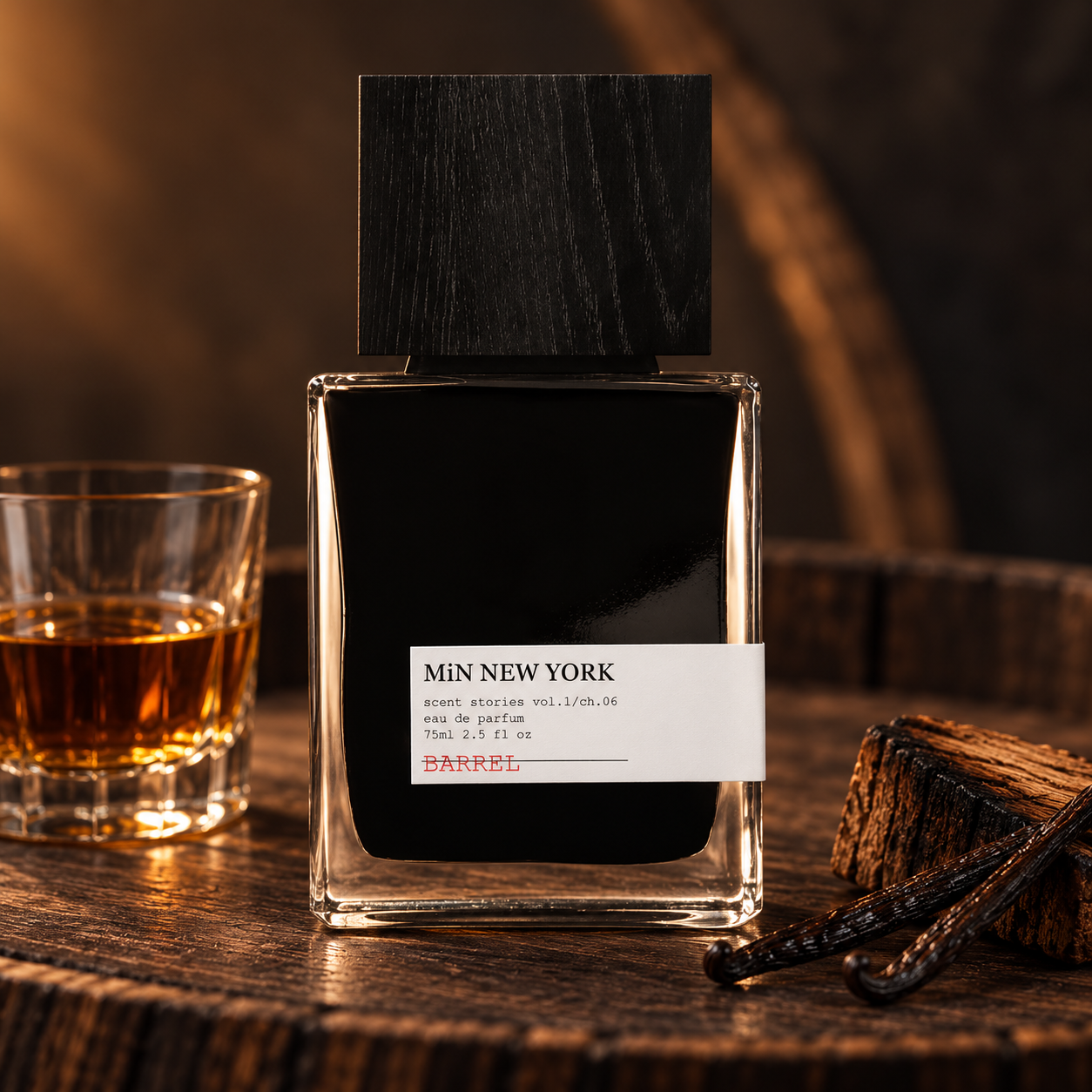 MiN NEW YORK Barrel on aged oak beside a glass of rum, toasted wood, and vanilla pods in warm amber light.