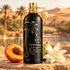 Montale Aqua Palma beside peach and white flowers, with palms and desert dunes in warm golden light.