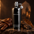 Montale Aoud Cuir d’Arabie beside brown leather gloves, oud wood, and a tobacco leaf on dark stone in warm amber light.