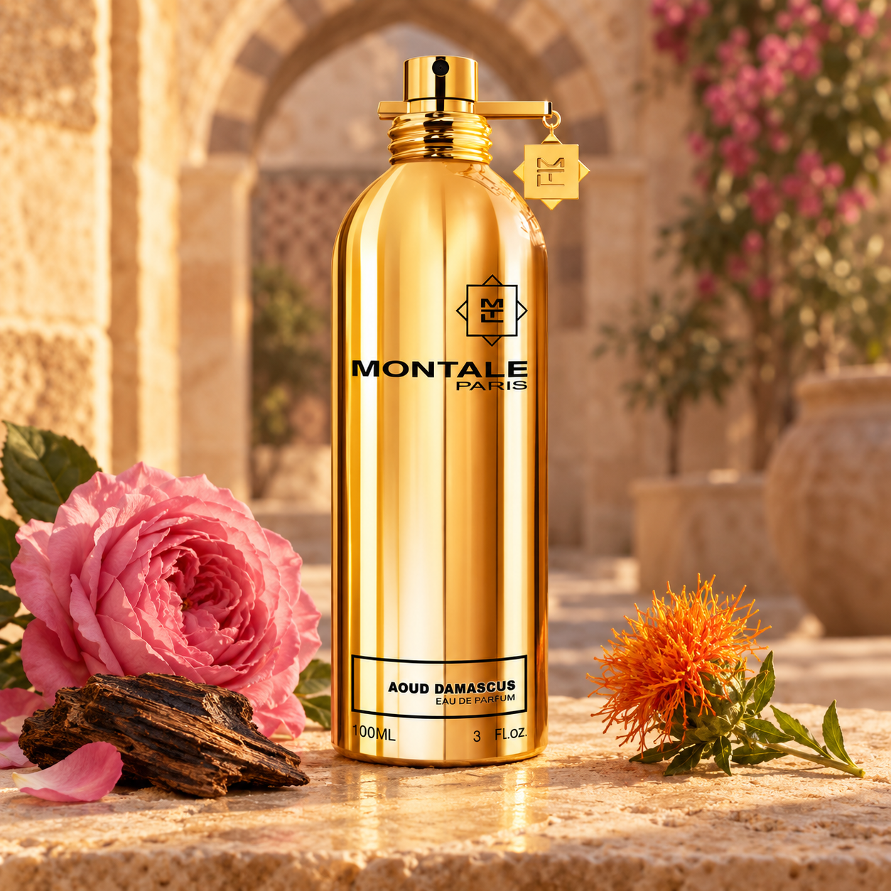 Montale Aoud Damascus beside a pink rose, orange safflower, and oud wood on sunlit limestone, with a softly blurred courtyard arch.