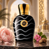 Moresque Aristoqrati on dark polished stone beside blush peony, pink geranium, and nutmeg, with softly lit ivory arches and gold details behind it.