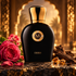 Moresque Emiro perfume with a red rose, geranium, wood and amber resin on dark stone before softly lit arches.