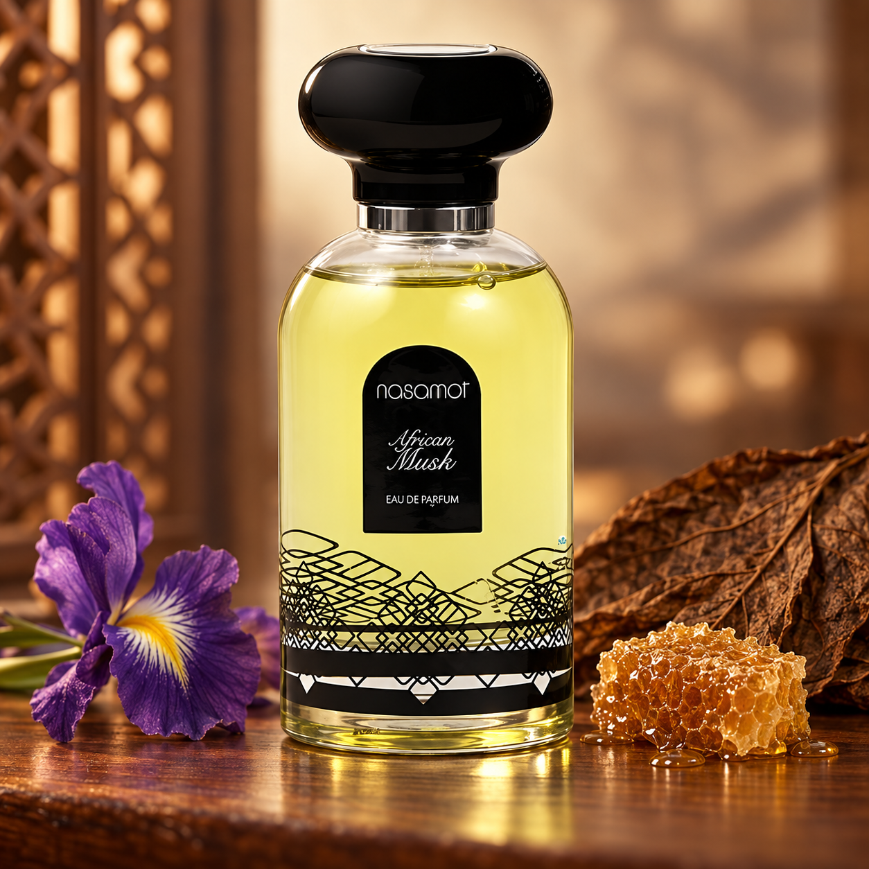 Nasamat African Musk beside a purple iris, golden honeycomb, and a tobacco leaf on polished wood in warm amber light.