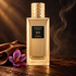 Navitus Desir Infini bottle on dark wood beside brown leather and a purple saffron crocus, with warm light and a wisp of smoke.