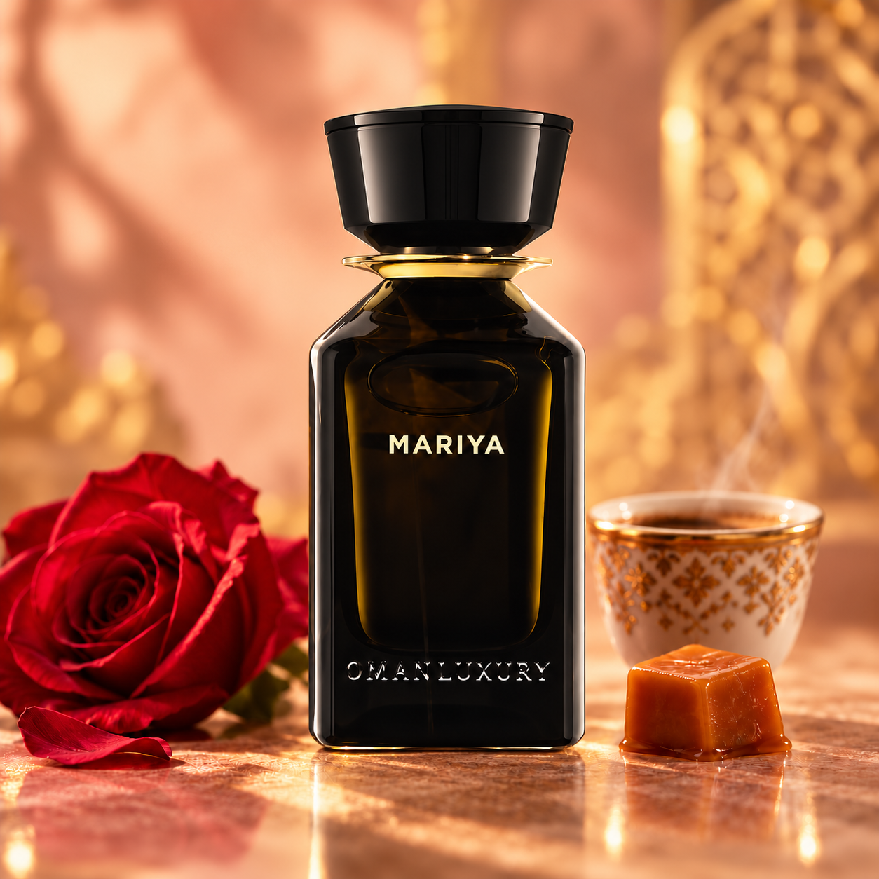 Omanluxury Mariya dark bottle beside a red rose, caramel and an ornate coffee cup in warm gold and blush light.