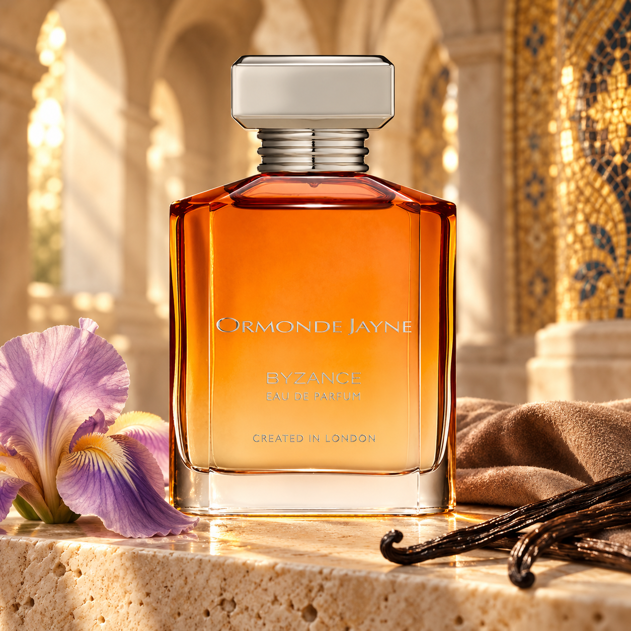 Ormonde Jayne Byzance with violet iris, suede, and vanilla pods against sunlit stone arches and gold mosaic.