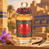 Penhaligon’s Babylon on sunlit sandstone beside saffron crocus, nutmeg, and vanilla pods, with ancient-inspired brick architecture behind it.